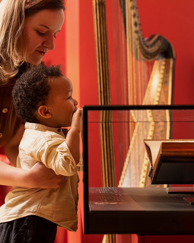 A child and adult looking at exhibits in the RCM Museum